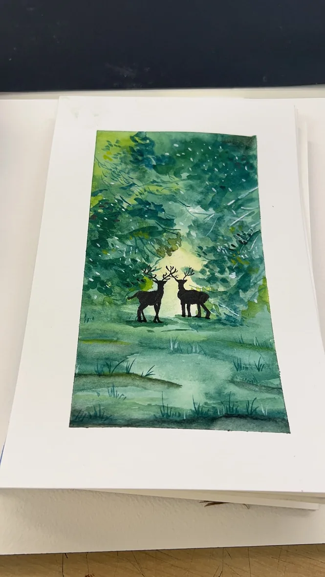 Watercolor of two deer silhouettes in a glowing green forest