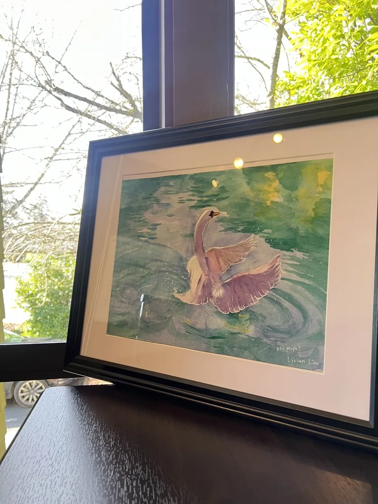 Watercolor of a swan spreading its wings on green water